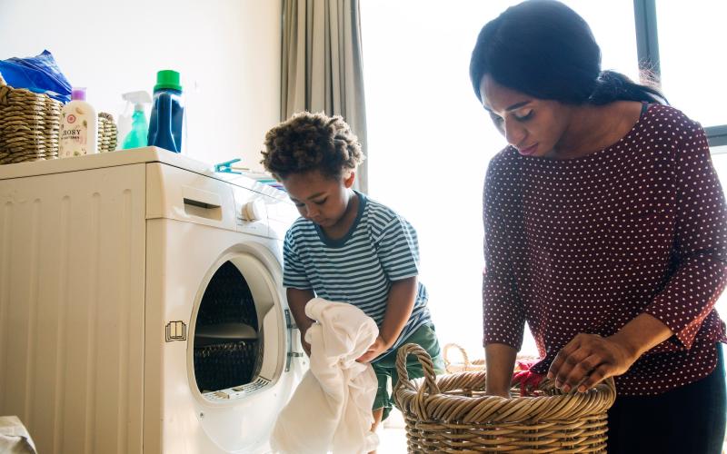 Vrouw met zoon doen de was